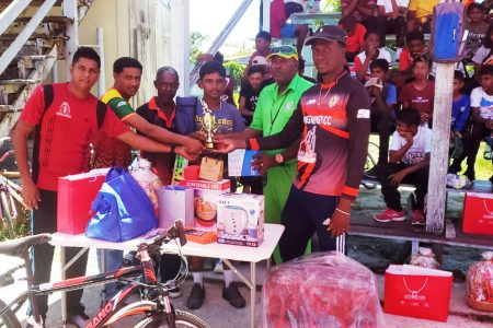 Cricketer of the Academy Komalchan Ramnarace receiving his prizes from the coaches 
