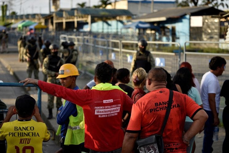 FILE PHOTO: People gather outside the Penitenciaria del Litoral prison after a riot, in Guayaquil, Ecuador April 14, 2023. REUTERS/Vicente Gaibor del Pino/File Photo