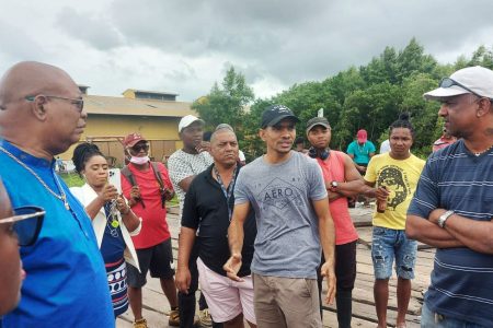 Minister of Public Works Juan Edghill (left) meeting with some of the affected fishermen