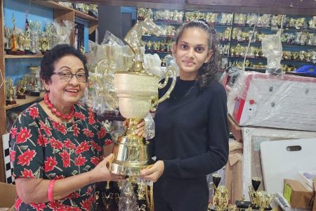 Honorary President of KMTF Mrs. Chan Kennard  receives one of the main prize trophies from Amy Anuradha Gomes of Trophy Stall.
