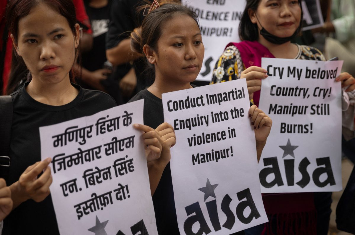 Protestors hold placards as they attend a protest against the alleged sexual assault of two tribal women in the eastern state of Manipur, in New Delhi, India, July 21, 2023. REUTERS/Adnan Abidi