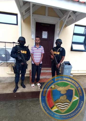 Michael Andrew Morgan (centre) when he was arrested by CANU.