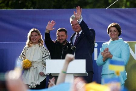 Ukrainian President Volodymyr Zelenskiy (second from left), his wife Olena Zelenska (left), Lithuanian President Gitanas Nauseda (second from right) and his wife Diana Nausediene attend a ceremony during which a Ukrainian flag from the frontline of the war with Russia was delivered by activists, on the sidelines of a NATO leaders summit in Vilnius, Lithuania July 11, 2023. REUTERS/Kacper PempelReuters