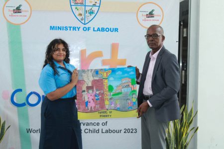The Ministry of Labour yesterday held a prize-giving ceremony for its Art Competition where young artists  received plaques, certificates and other incentives for their best portrayal of World Day Against Child Labour’s theme “Social Justice for All. End Child Labour.”   Joannah Manauf won the top prize. In this Ministry of Labour photo, Manauf (left) and Minister of Labour Joseph Hamilton hold up the work of art.