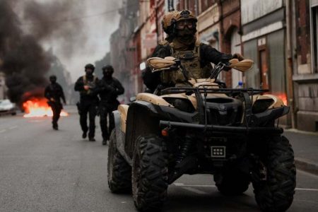 Officers ride a vehicle in Lille, northern France, on Friday during riots following the death of Nahel M., a 17-year-old killed by a French police officer in a Paris suburb. (Nacho Doce/Reuters)