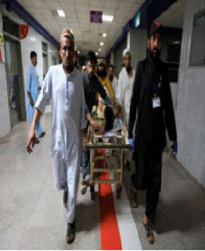 People transport a man, who was injured after a blast in Bajaur district of Khyber Pakhtunkhwa, at the Lady Reading Hospital in Peshawar, Pakistan July 30, 2023. (Reuters photo)