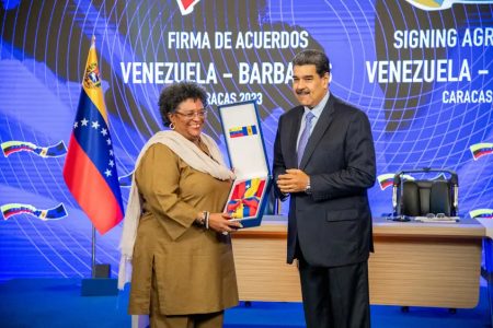 Prime Minister Mia Amor Mottley (left) being awarded by Venezuelan President Nicolas Maduro