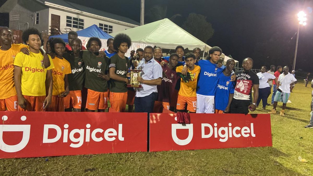 The victorious Dolphin outfit receiving the Georgetown zonal championship trophy in the Digicel Schools Football Championship, after defeating Excelsior in the final at the Ministry of Education ground, Carifesta Avenue 
