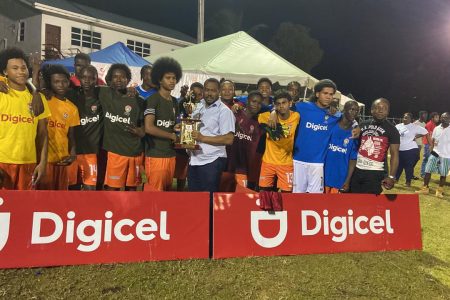 The victorious Dolphin outfit receiving the Georgetown zonal championship trophy in the Digicel Schools Football Championship, after defeating Excelsior in the final at the Ministry of Education ground, Carifesta Avenue 
