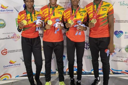 The record breaking quartet of Tianna Springer, Javon Roberts, Narissa McPherson and Malachi Austin pose with their gold medals on Thursday night at the Hasely Crawford Stadium in Trinidad