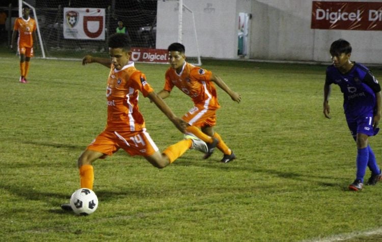 Shakeel Mark of Waramuri in the process of attempting a lobbed pass against St Ignatius during their semi-final encounter in the Digicel Schools Football Championship
