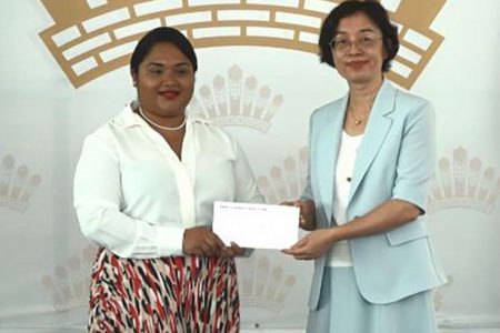 First Lady Arya Ali (left) receiving a contribution towards her initiative from Guo Haiyan, Ambassador of the People’s Republic of China. (DPI photo)
