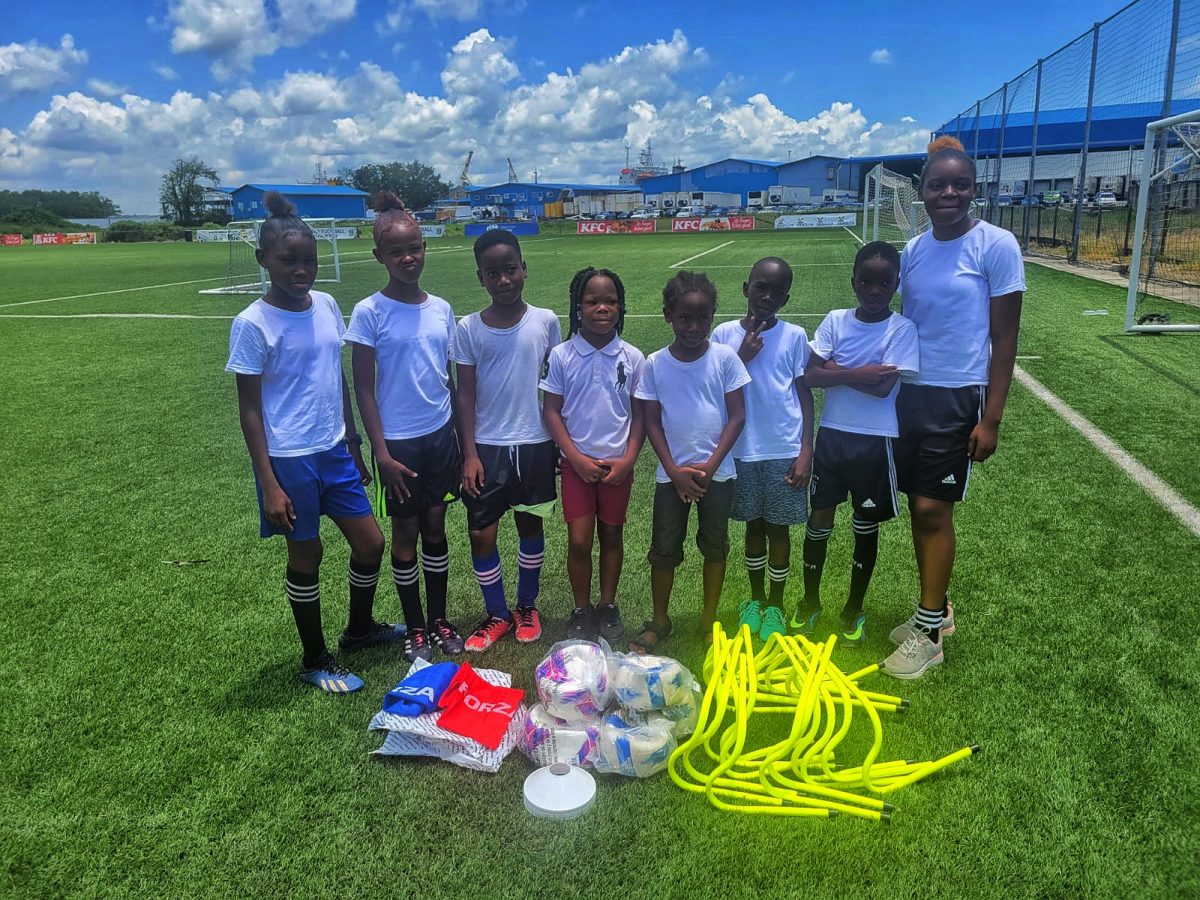 Several participants of the Fruta Conquerors Summer Grassroots Programme posing with the equipment that was donated by the GFF via its MFAP initiative
