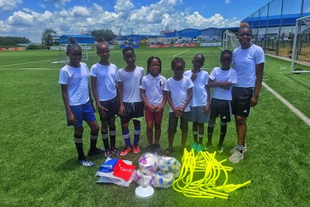 Several participants of the Fruta Conquerors Summer Grassroots Programme posing with the equipment that was donated by the GFF via its MFAP initiative
