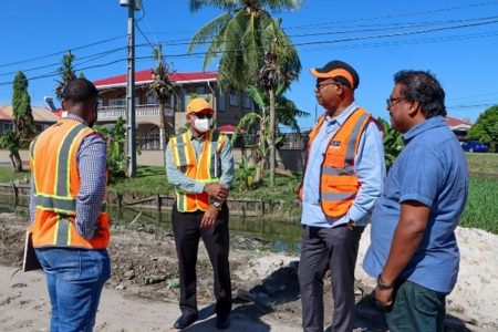 Minister of Public Works Juan Edghill with contractors at the project site recently