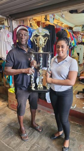 Mark `Jumbie’ Wiltshire receives the Trophy Stall trophy from Tanda Crossman of the Trophy Stall.