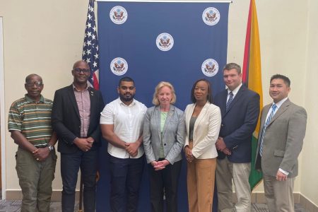 US Ambassador Sarah-Ann Lynch is fourth from left and GCCI President Kester Hutson is second from left. 