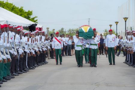 The coffin of Dr Roger Luncheon being taken into the Arthur Chung Conference Centre (Office of the President photo)