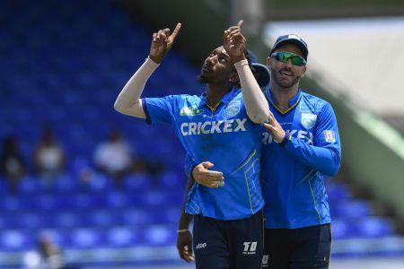 Left-arm spinner Khary Pierre is congratulated by captain Faf du Plessis after taking a wicket yesterday. (Photo courtesy CPLT20/Getty Images) 