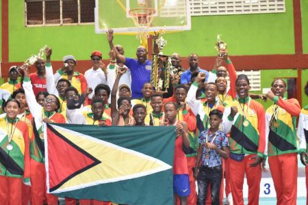 Home turf defended!! Members of Team Guyana in full celebratory mode after successfully retaining their overall title in the Winfred Braithwaite Caribbean Schoolboys and Juniors Championship at the National Gymnasium, Mandela Avenue 