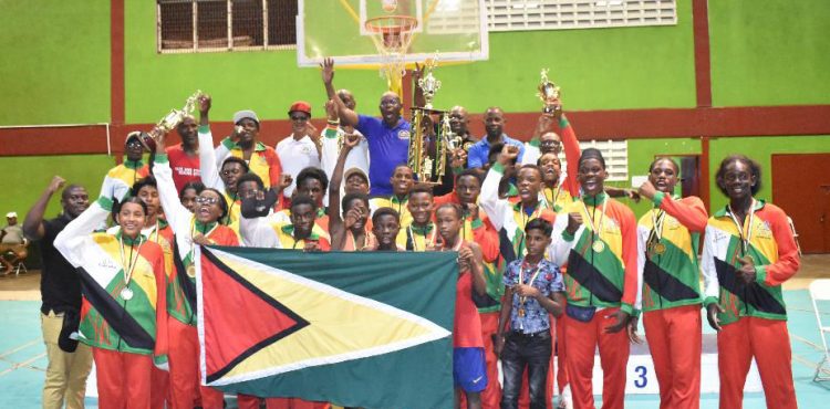 Home turf defended!! Members of Team Guyana in full celebratory mode after successfully retaining their overall title in the Winfred Braithwaite Caribbean Schoolboys and Juniors Championship at the National Gymnasium, Mandela Avenue 