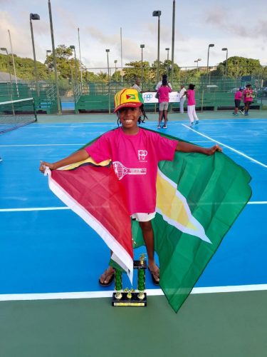 Star athlete Zion Hickerson drapes himself with the Guyana flag after winning the inaugural Chatoyer’s Tennis Invitational 2023 event in St Vincent and Grenadines.
