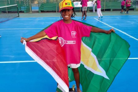 Star athlete Zion Hickerson drapes himself with the Guyana flag after winning the inaugural Chatoyer’s Tennis Invitational 2023 event in St Vincent and Grenadines.
