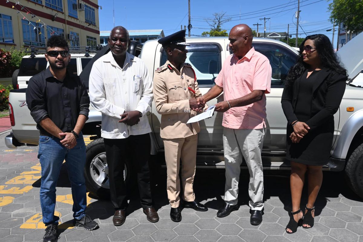 Representative of Tony’s Auto Spares, Jason Ramcharan (second from right) presenting the document for the vehicle to Chief Fire Officer, Gregory Wickham 