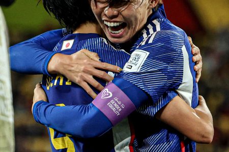  Japanese players celebrate after their 4-0 defeat of Spain.