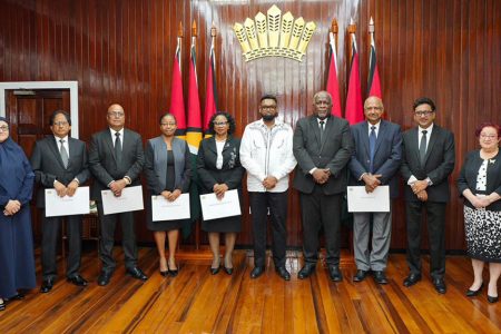 Members of the JSC holding their instruments of appointment after having taken the oath before President Irfaan Ali (sixth from left)