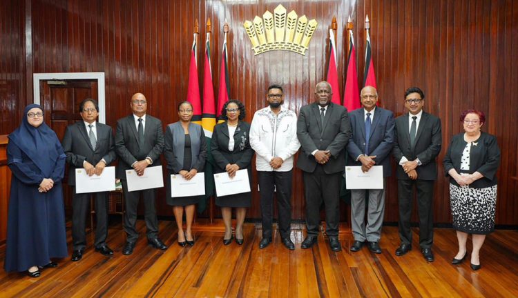 Members of the JSC holding their instruments of appointment after having taken the oath before President Irfaan Ali (sixth from left)