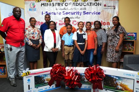 The Ketley Primary School won the Ministry of Education’s Literacy Bee Competition. The Deputy Headteacher,  Alexis Alleyne-Carter, and students Antwon Henry and Angelina Deonarine received the prizes on behalf of the school on Thursday at the National Literacy Department (NLD). The two students represented Ketley Primary in the competition.  (Ministry of Education photo)