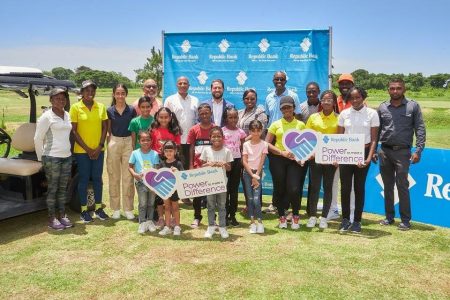 In the photo above, representatives of Republic Bank Ltd., and the Lusignan Golf Club (LGC) meet with some of the children who will be involved in the programme.
