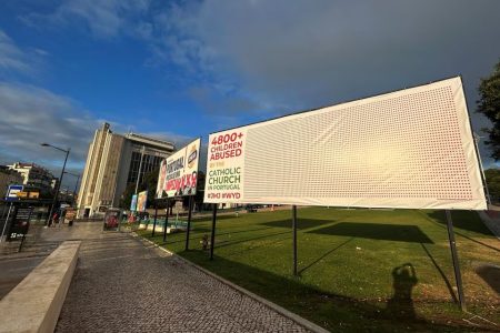 A billboard denounces children sexual abuse by members of the Portuguese Catholic church during the XXXVII World Youth Day celebrations 