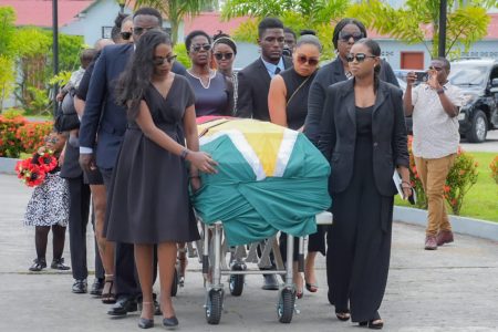 Relatives conveying the coffin of the late former Head of the Presidential Secretariat, Dr Roger Luncheon who passed away earlier this month at the age of 74. A funeral service was held at the Arthur Chung Conference Centre yesterday. (Office of the President photo)