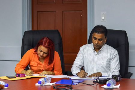 Bishram Kuppen, Permanent Secretary (right) and a Perba representative signing the contract (Ministry of Labour photo)