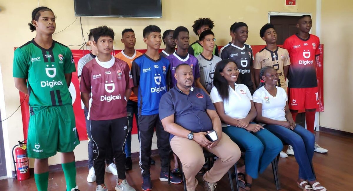 12 of the participating schools display their new team jerseys which are part of the complete team kits that were presented by the Petra Organization and Digicel. Also in the photo [sitting from left] are Petra Organization Co-Director ,Troy Mendonca, Gabriella Chapman, Communications Director of Digicel, and National Coordinator Lavern Fraser-Thomas
