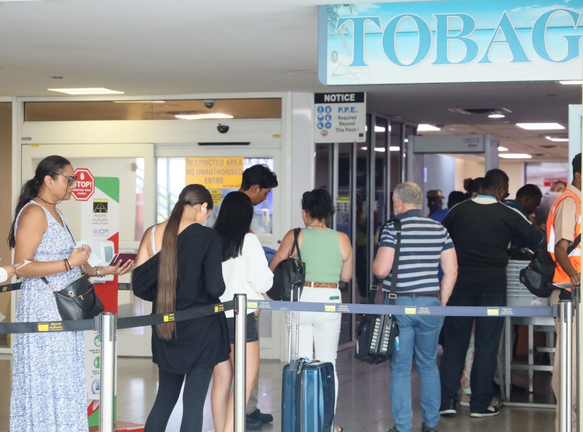 Members of the public who were affected by the Caribbean Airlines flight disruptions stand in line to try to get on to a flight to Tobago at Piarco International Airport on Monday.