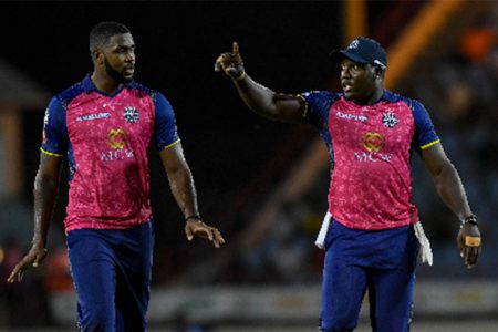 Barbados Royals captain Rovman Powell gives instructions to young left-arm seamer Obed McCoy during Thursday night’s defeat to St Lucia Kings. (Photo by CPLT20/Getty Images) 