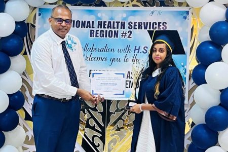 Minister of Health Dr Frank Anthony with the best graduating student Measasha Ramdass