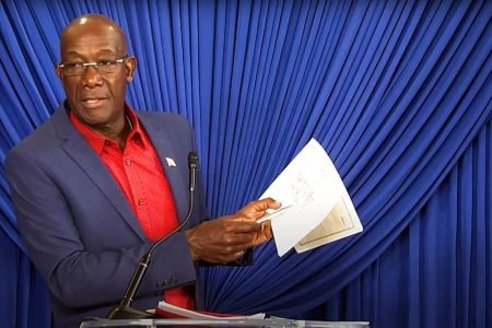 FLASHBACK: Prime Minister Dr Keith Rowley holds up copies of what he said are his Integrity Commission declaration forms during his press conference in Tobago in December 2021.