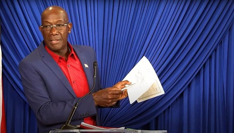 FLASHBACK: Prime Minister Dr Keith Rowley holds up copies of what he said are his Integrity Commission declaration forms during his press conference in Tobago in December 2021.