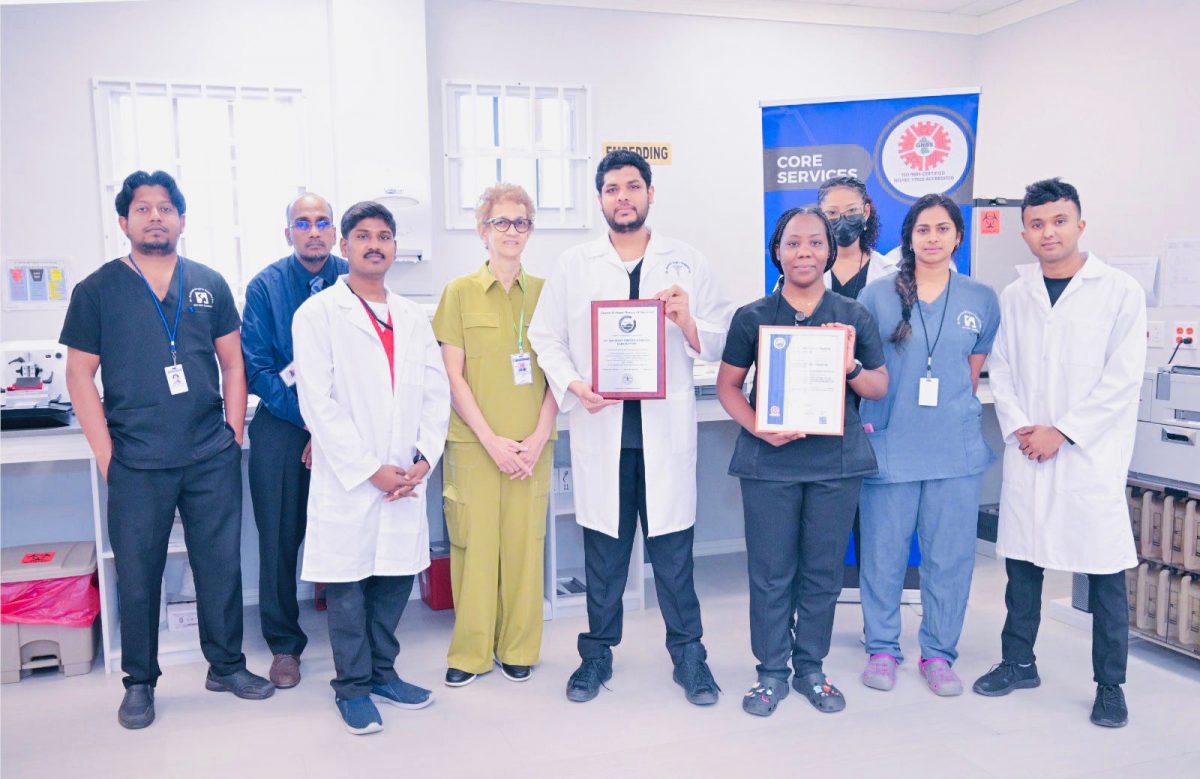 Dr Madhu Singh (fourth from left) with hospital staff holding up the certificates 