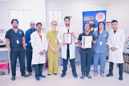 Dr Madhu Singh (fourth from left) with hospital staff holding up the certificates 