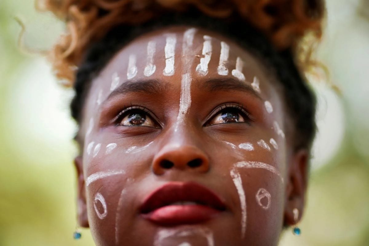 A slave descendant person, or a Quilombola looks on during a protest for recognition and support of Indigenous people in education and against Brazilian President Jair Bolsonaro's Government in Brasilia, Brazil October 7, 2021. REUTERS/Adriano Machado