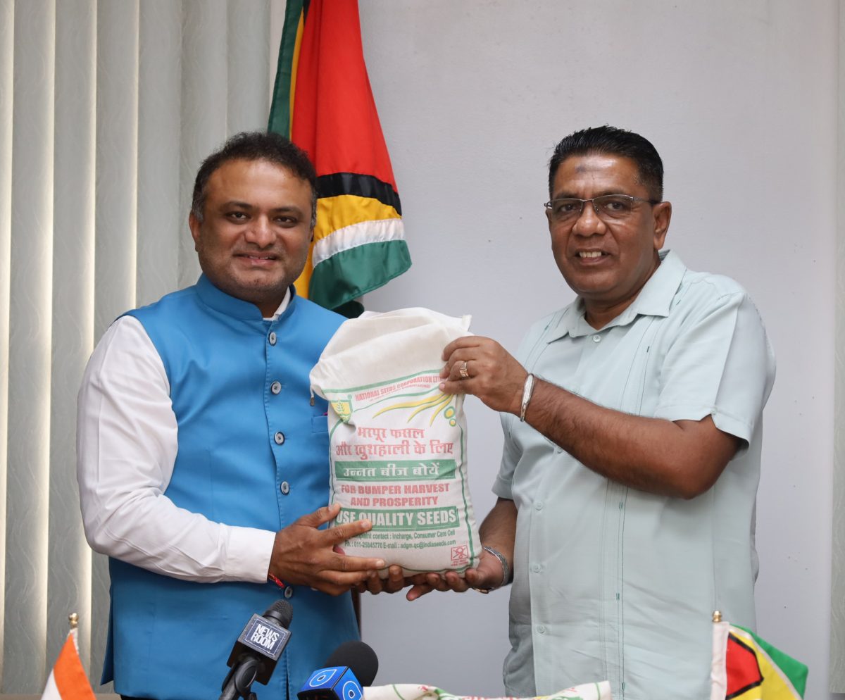 Outgoing Indian High Commissioner to Guyana, Dr K J Srinivasa (left) presenting the millet seeds to Agriculture Minister, Zulfikar Mustapha (Ministry of Agriculture photo)