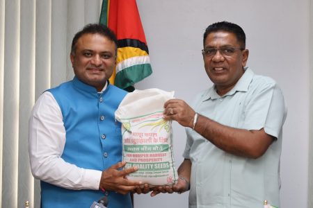 Outgoing Indian High Commissioner to Guyana, Dr K J Srinivasa (left) presenting the millet seeds to Agriculture Minister, Zulfikar Mustapha (Ministry of Agriculture photo)