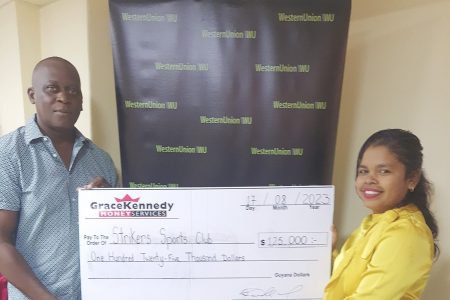Marketing Assistant Tina Seabra-Gibson hands over the sponsorship check to
co-organizer Roderick Harry.