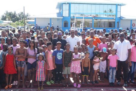 Some of the registrants of the ‘Learn to Swim’ programme pose for a photo with Director of Sport, Steve Ninvalle, President of the GOA, Godfrey Munroe and head coach, Paul Mahaica following the closing ceremony
yesterday at the National Aquatic Centre. (Emmerson Campbell photo)
