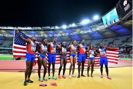 The US male and female 4x100 relay teams after their gold medal runs. (Reuters photo)